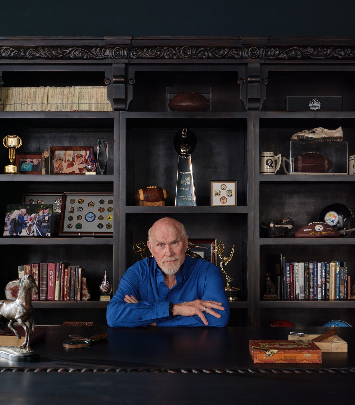 Terry Bradshaw seated at his desk
